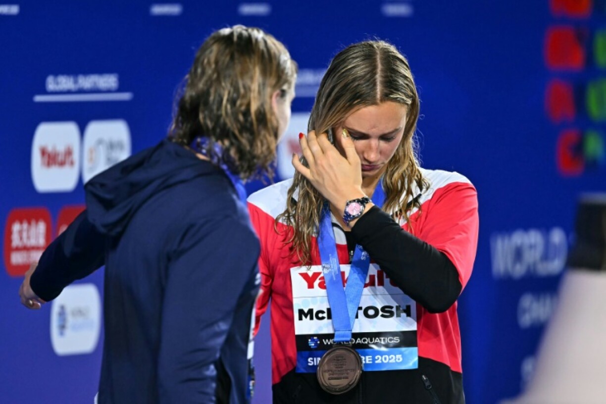 Summer McIntosh (right) was tearful after having to settle for bronze in the 800m freestyle behind Katie Ledecky (left)