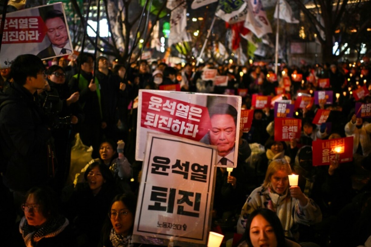People take part in a candlelight vigil as they call for the resignation of South Korea President Yoon Suk Yeol