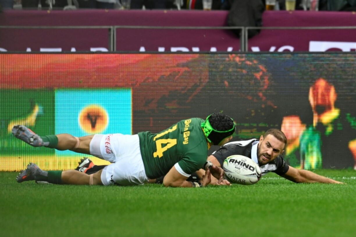 South Africa winger Cheslin Kolbe (L) scores against the Barbarians at Cape Town Stadium
