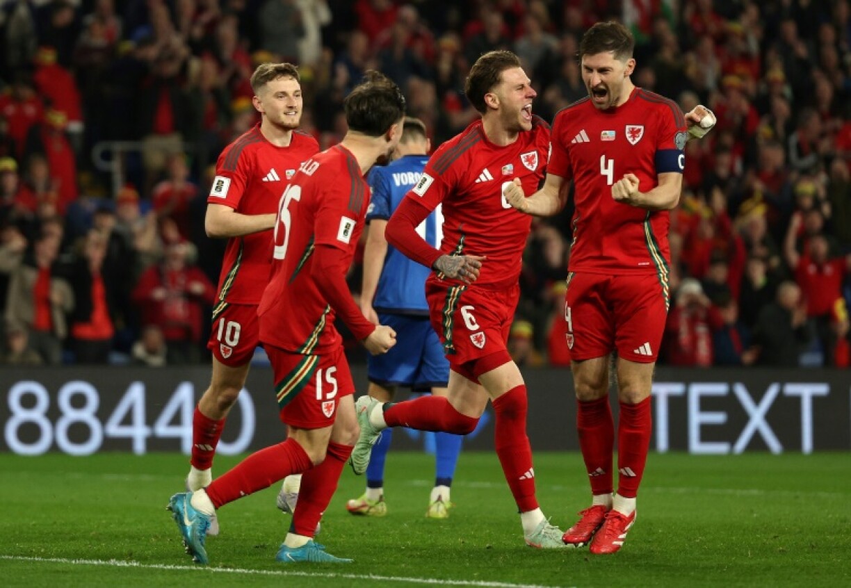 Captain Ben Davies (R) celebrates scoring the second goal for Wales in their 3-1 win over Kazakhstan