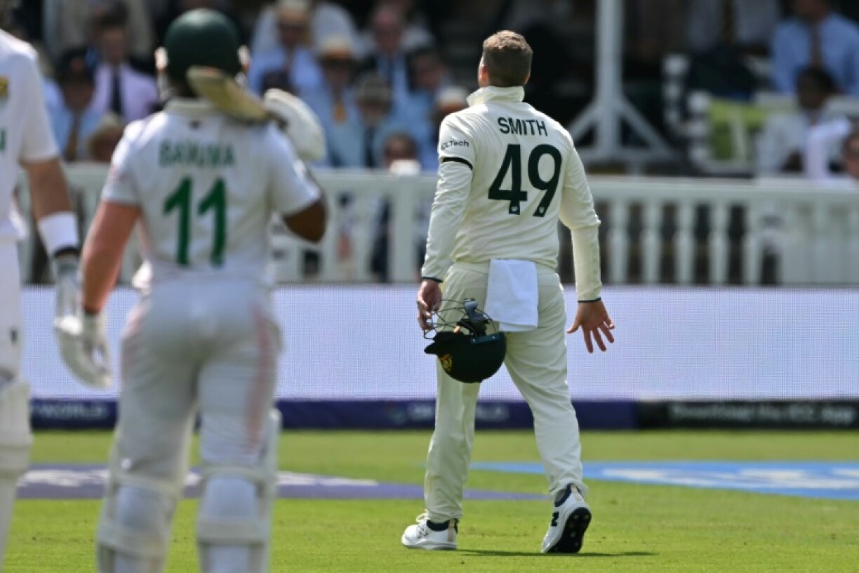 Australia's Steve Smith leaves the field after suffering a finger injury while fielding in the slips during the WTC final against South Africa at Lord's