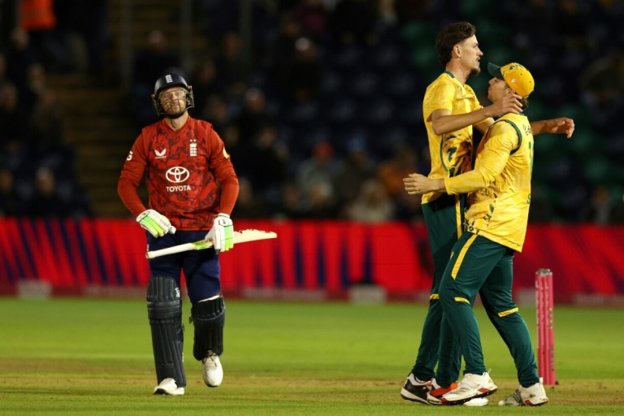 England's Jos Buttler (L) leaves the field after being dismissed by Marco Jansen (C) in the 1st T20 against South Africa at Sophia Gardens, Cardiff