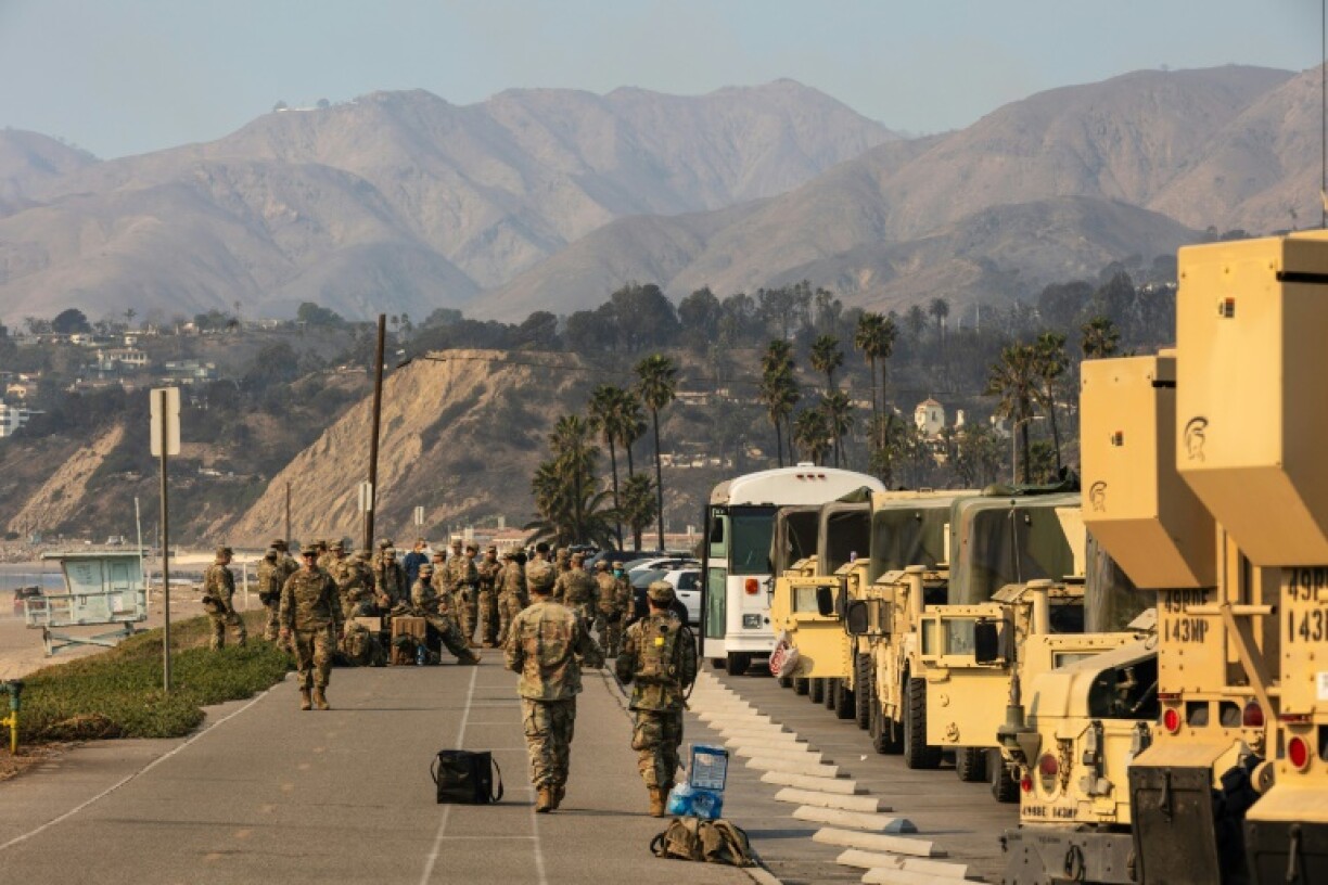 Members of the National Guard take a break along California's Pacific Coast Highway while assisting with various fires on January 10, 2025