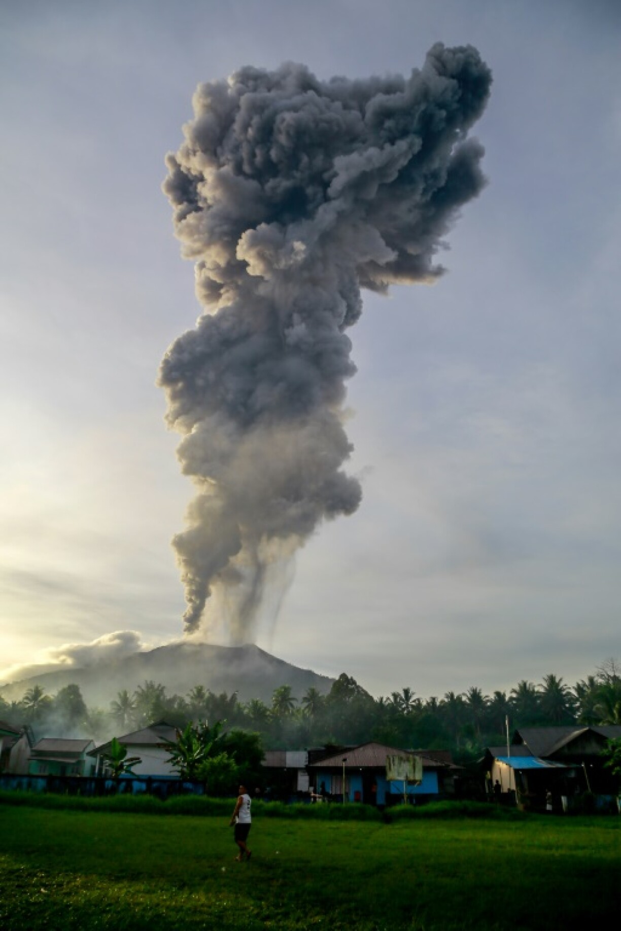 Volcanic ash rises during the eruption of Mount Ibu, as seen from Duono Village in West Halmahera, North Maluku province, on January 15, 2025