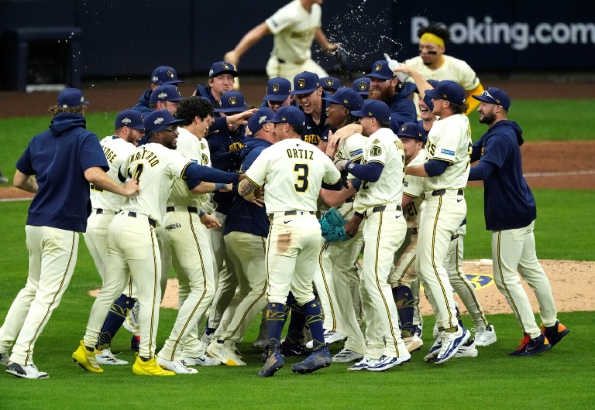 The Milwaukee Brewers celebrate after defeating the Chicago Cubs 3-1 to capture their MLB playoff series and advance to a National League Championship Series showdown with the defending champion Los Angeles Dodgers