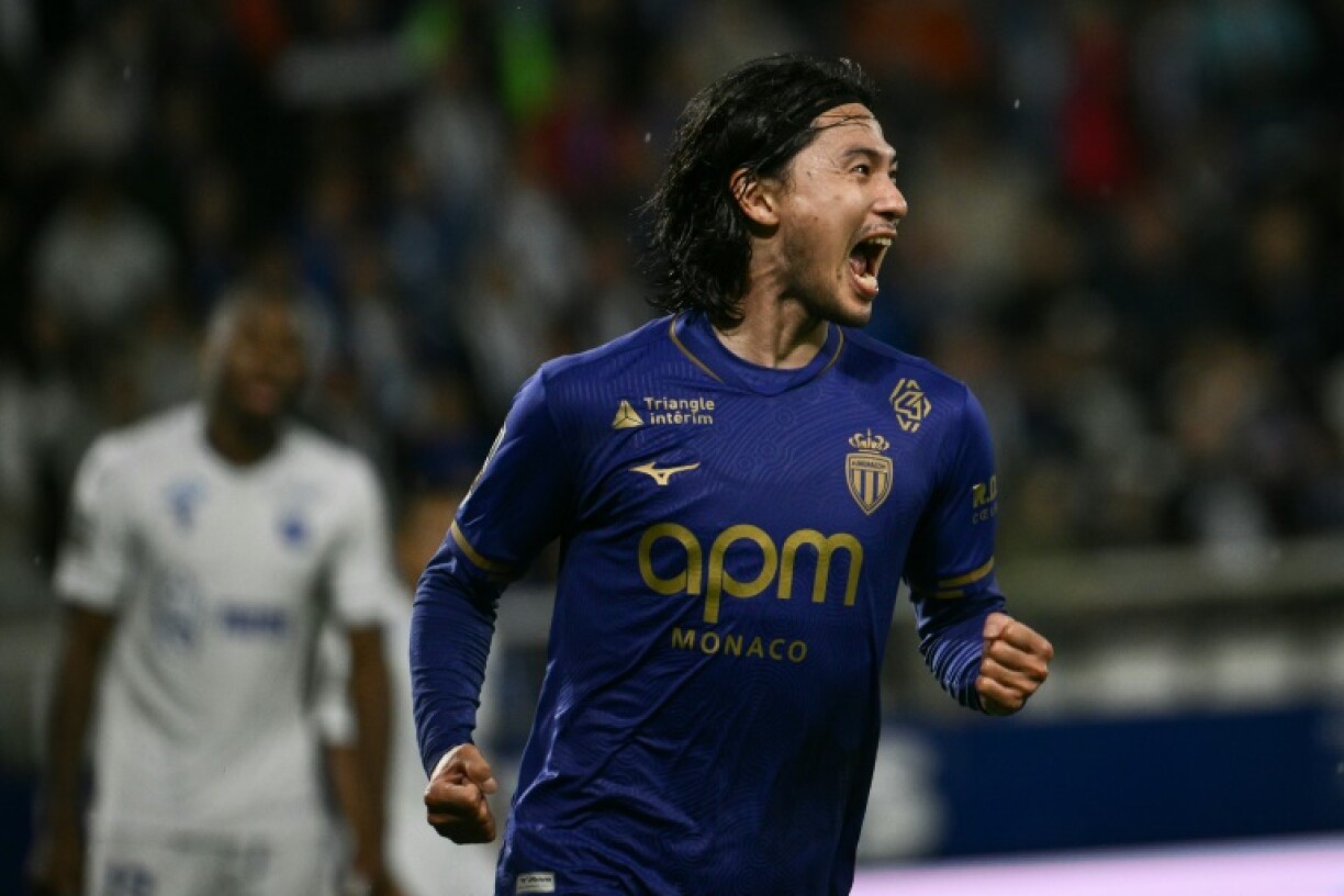Takumi Minamino celebrates putting Monaco ahead at Auxerre