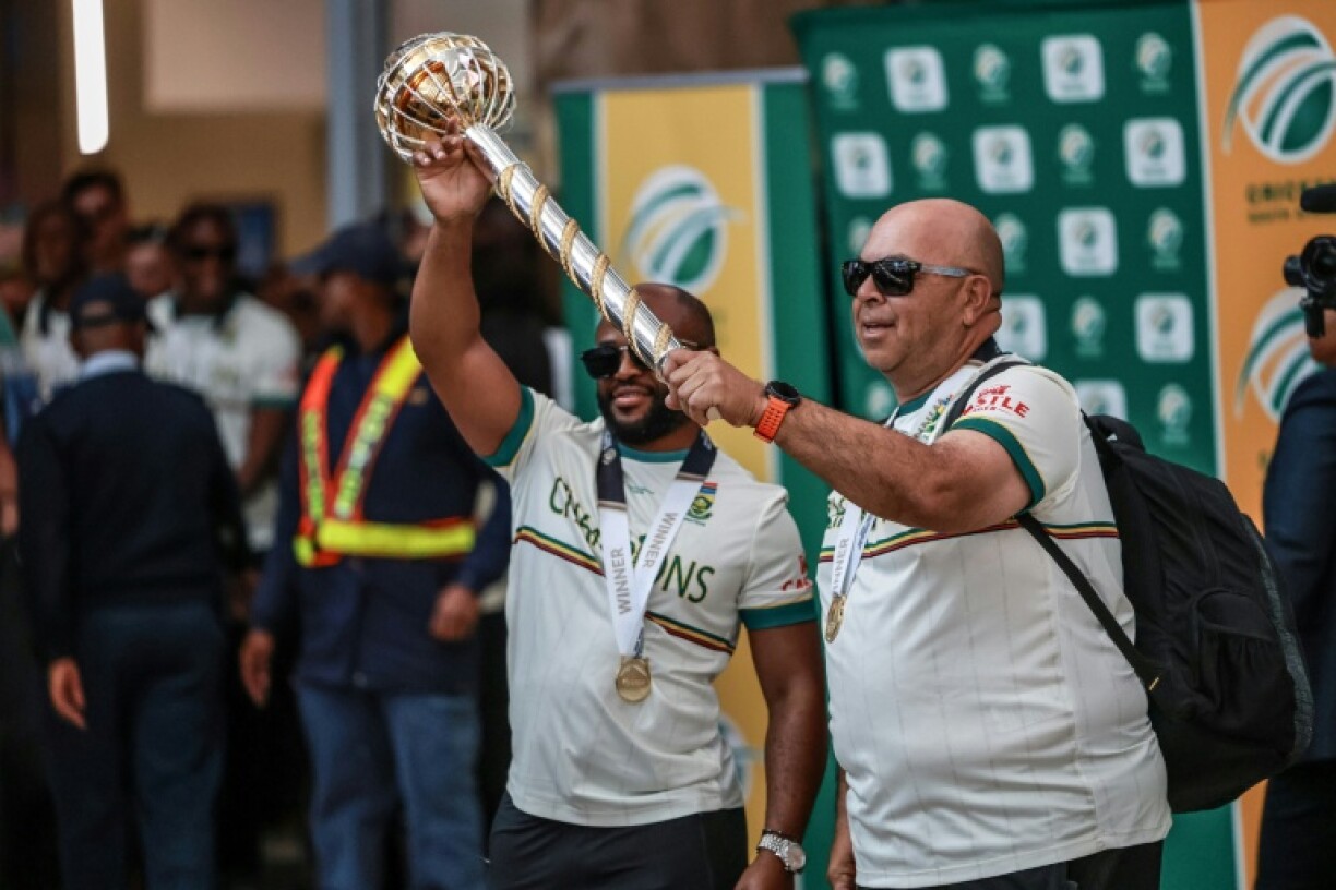 South Africa captain Temba Bavuma (L) and coach Shukri Conrad hold the Mace in Johannesburg on Wednesay after winning the World Test Championship in London last weekend.