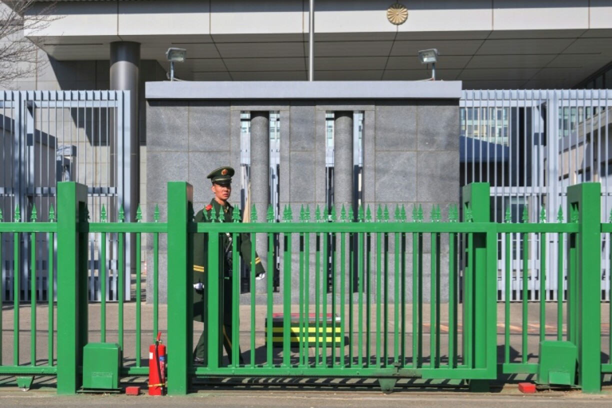 A member of security stands guard at the Japanese embassy in Beijing