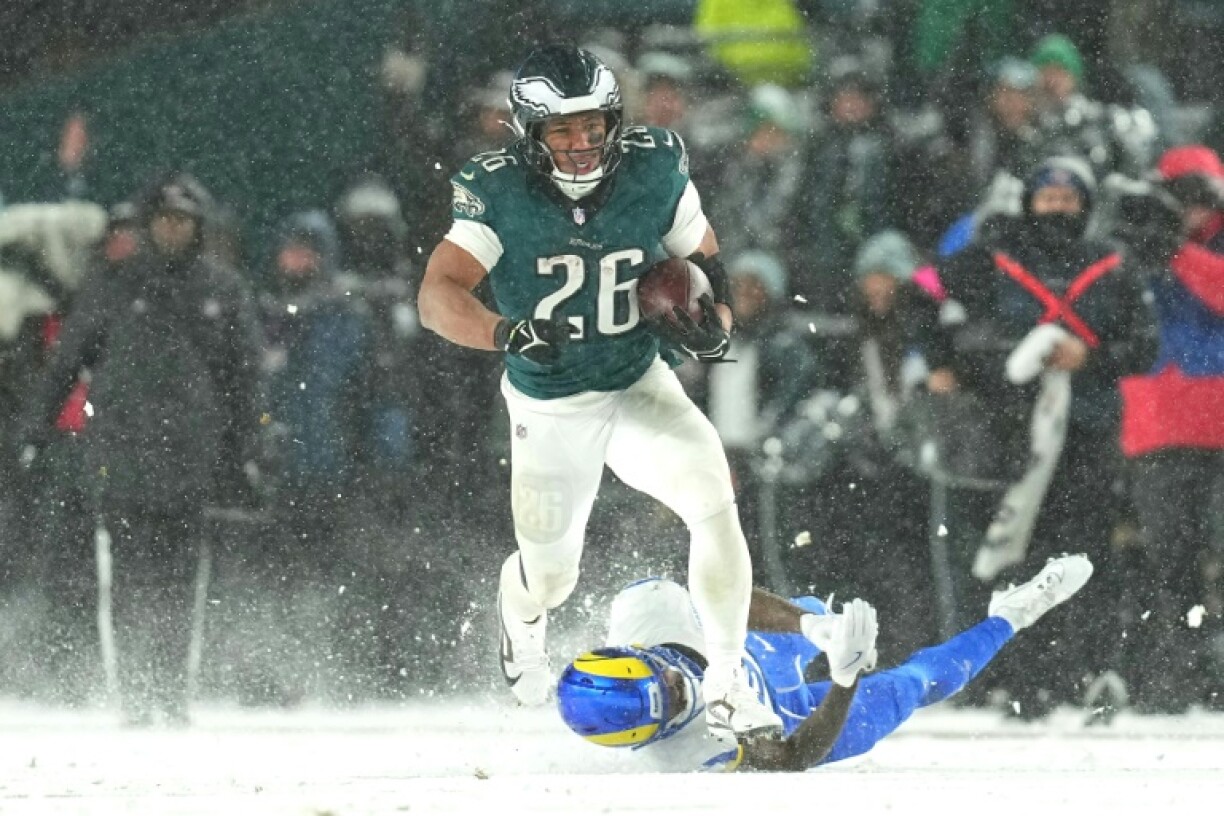 Saquon Barkely leaves the Los Angeles Rams defence in his wake in the Eagles 28-22 playoff victory