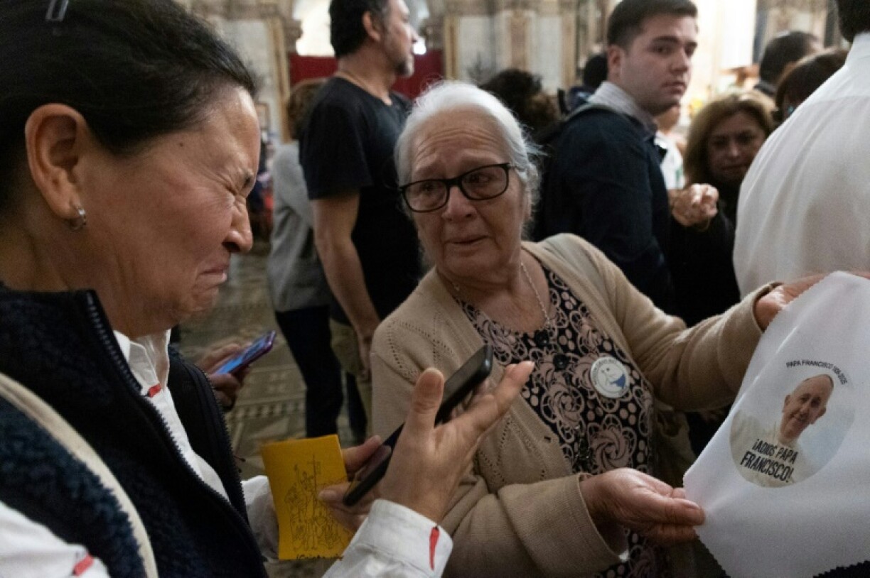 Women mourn during a mass for Pope Francis at Santiago Cathedral in Chile