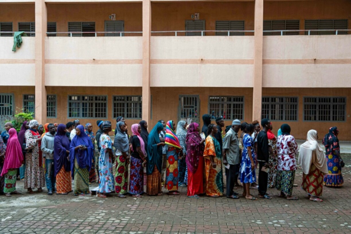 Voters queue at the Housseine Center polling station in Conakry on September 21, 2025