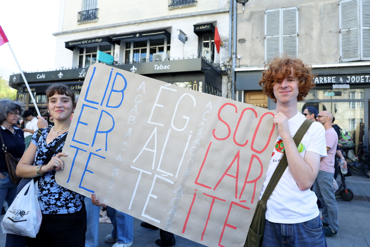high school students hold a placard which reads as 'Liberty, Equality, Schooling' handritten with the colors of the flag of France, during a gathering amid a nationwide protest movement over school conditions in Saint-Denis, north of Paris, on October 4, 2026.