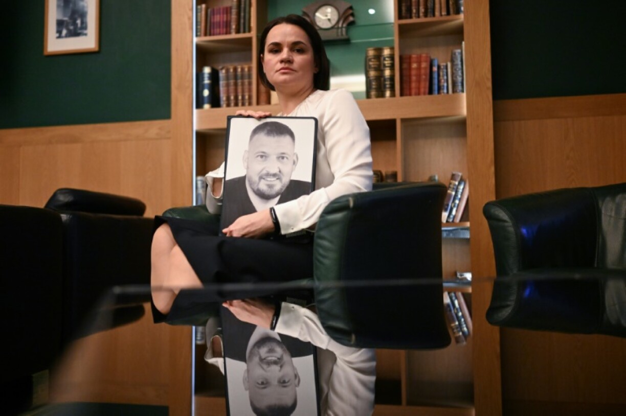 Svetlana Tikhanovskaya with a photo of her jailed husband, Sergei Tikhanovsky