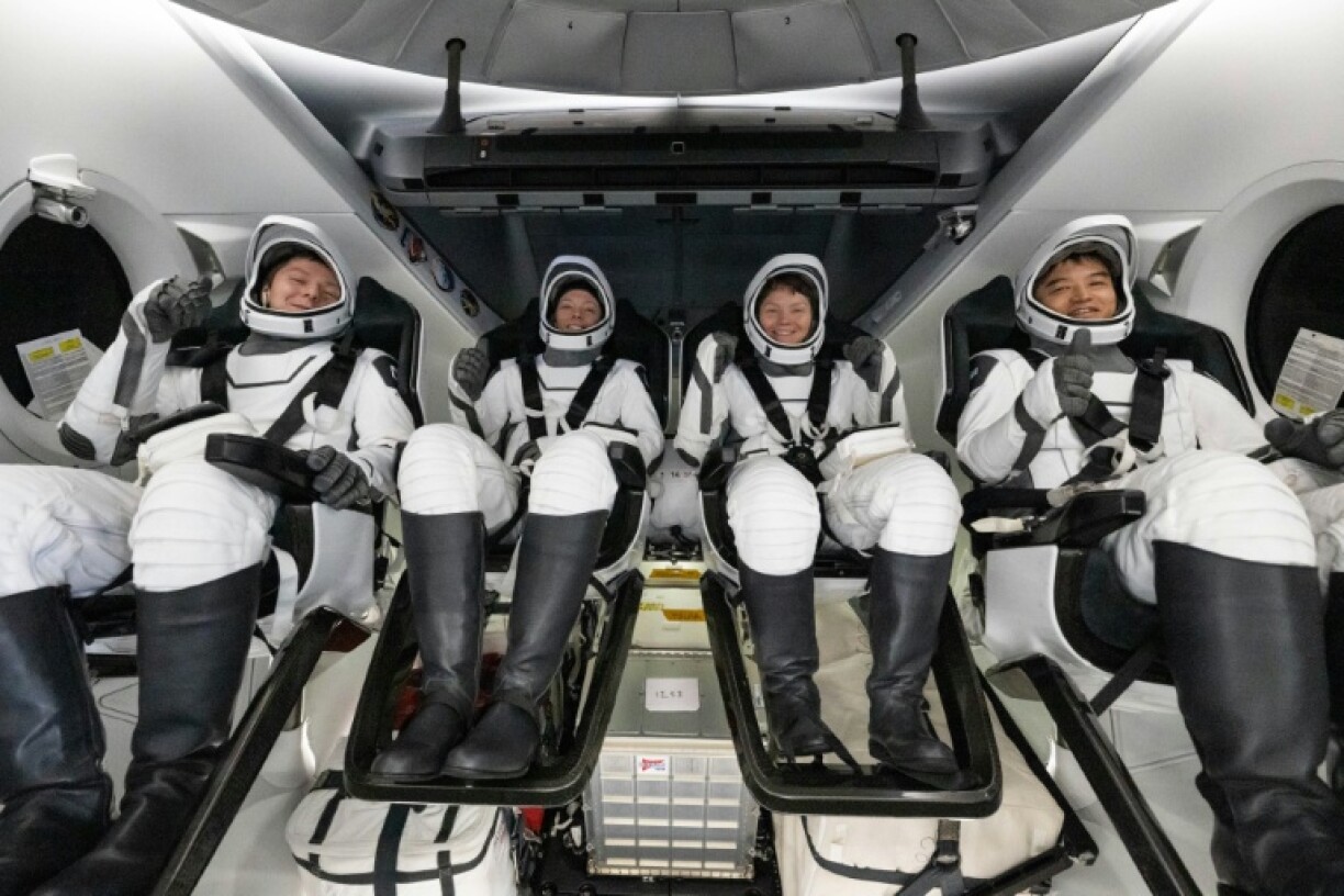 Russian cosmonaut Kirill Peskov, NASA astronauts Nichole Ayersand Anne McClain and Japan's Takuya Onishi inside the SpaceX capsule