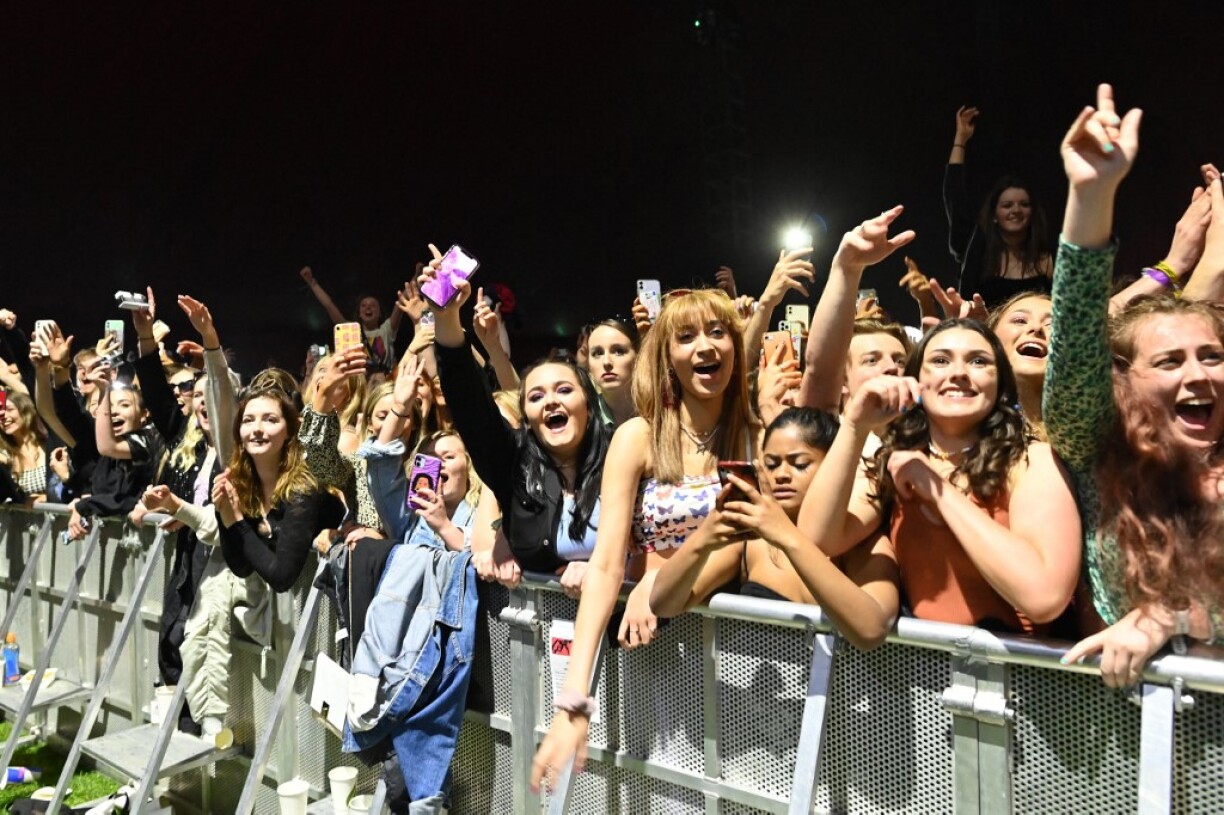 Thousands danced without face coverings at a music festival in northern England as the UK government permitted the country's first post-lockdown gig.