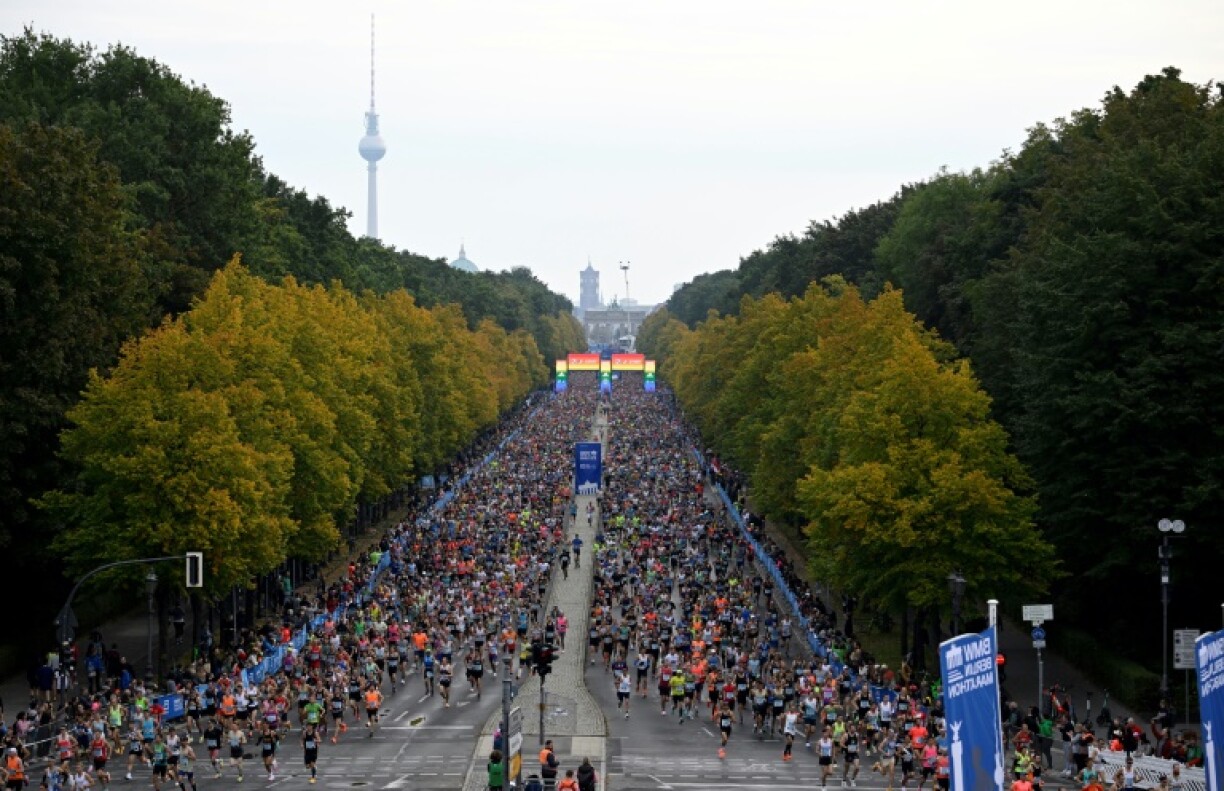 Runners at the Berlin Marathon in 2022, with the city's Brandenburg Gate and TV Tower in the background.