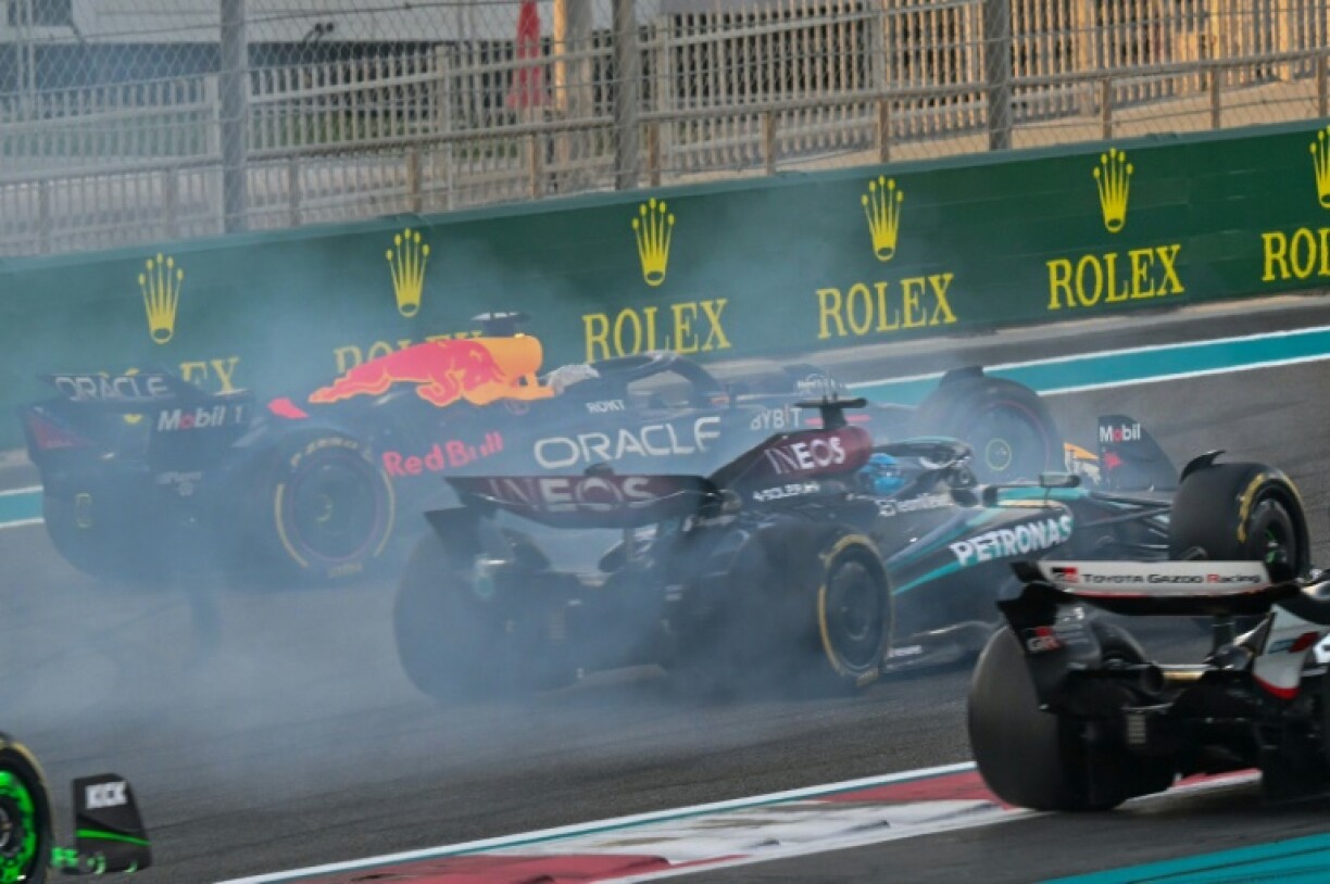 Red Bull's Max Verstappen (L) drives on after his collision with Oscar Piastri in Abu Dhabi