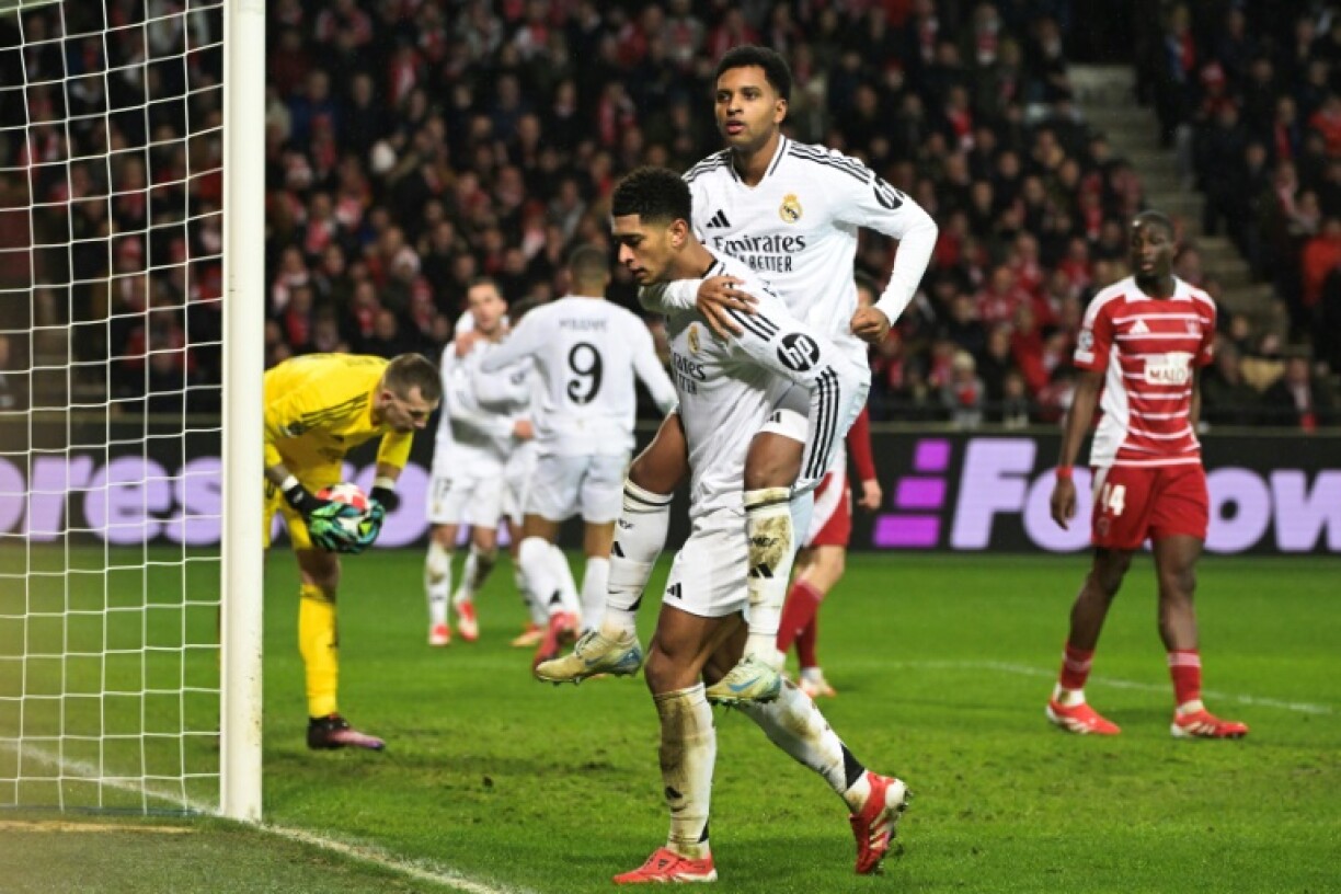 Real Madrid's English midfielder Jude Bellingham celebrates with teammate Rodrygo (top)