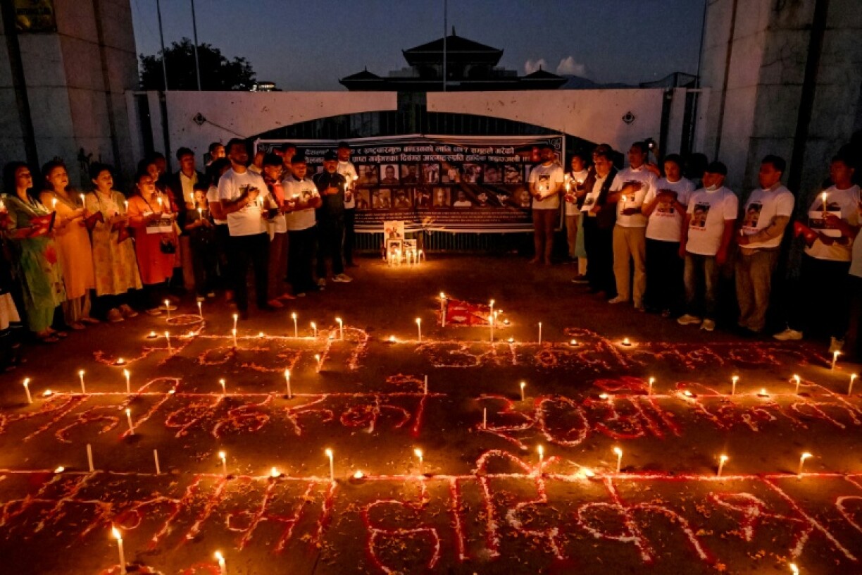 Family members hold a vigil for the dozens of people killed in the September 8–9 protests