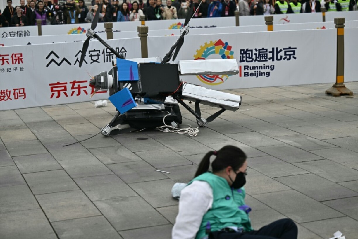 A robot loses control as it takes part in the half marathon in Beijing