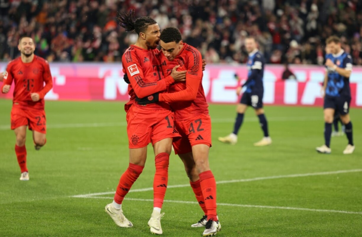 Bayern Munich forward Jamal Musiala (R) celebrates with Michael Olise