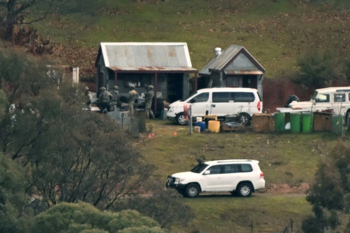 Australian police searched buildings for a gunman suspected of killing two officers