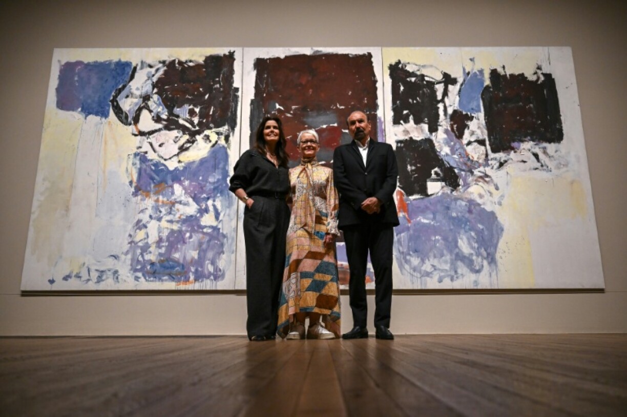 Director of the Tate Modern, Maria Balshaw, stands in front of the donated triptych by Joan Mitchell flanked by US-Argentinian businessman Jorge M. Perez and his wife Darlene Perez
