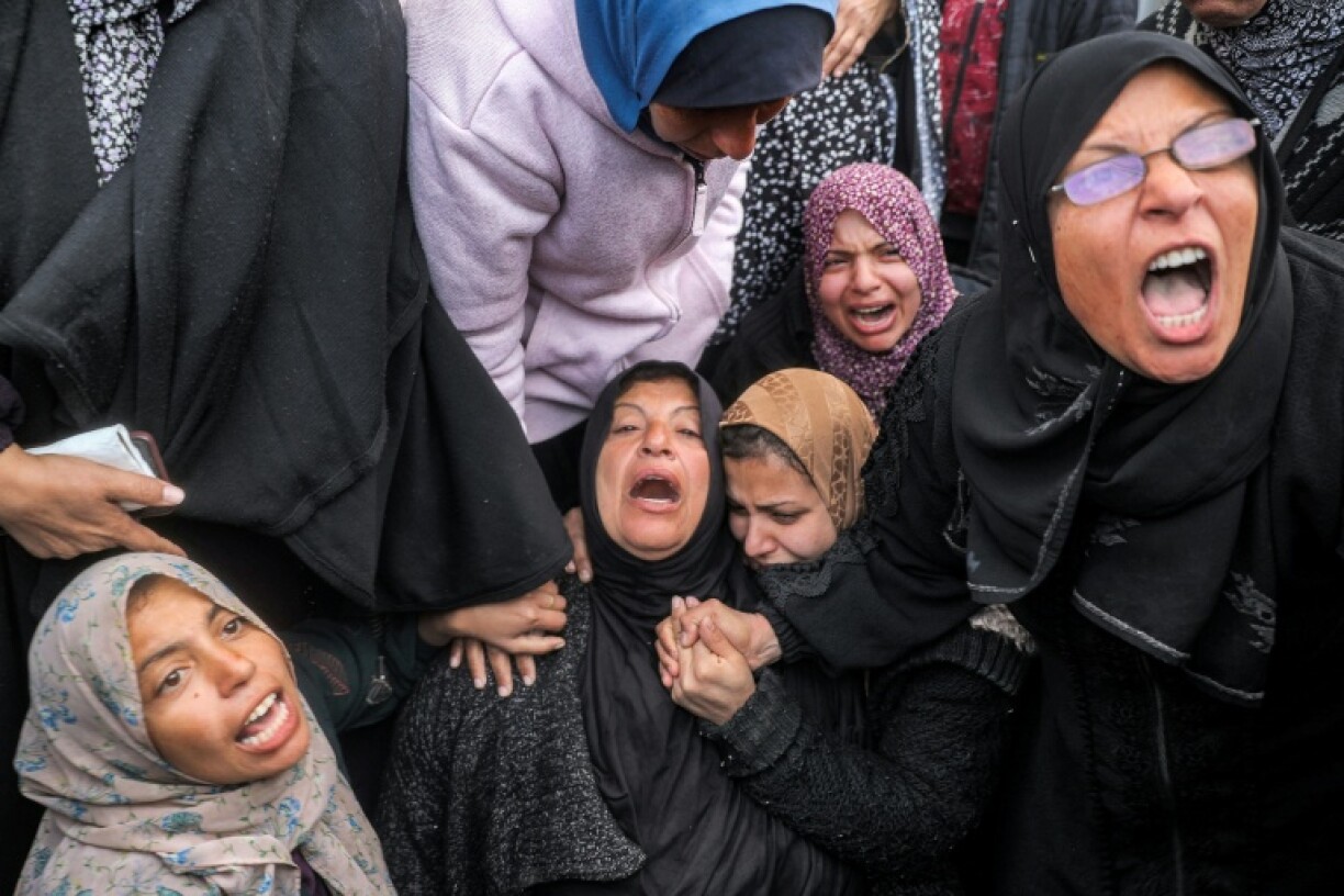 Women at a hospital in Deir el-Balah, central Gaza, mourn relatives killed by Israeli bombardment
