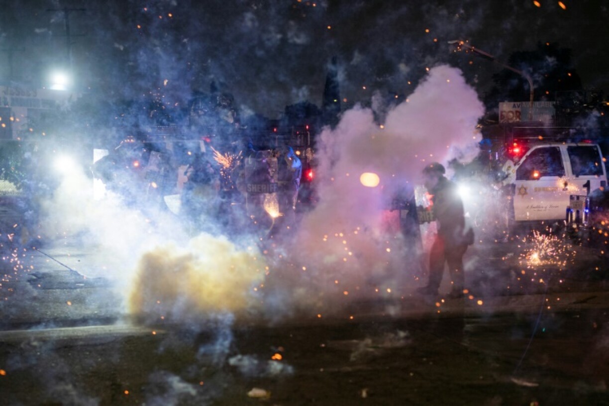 Two days of confrontations have seen federal agents shoot flash-bang grenades and tear gas toward crowds angry at the arrests of dozens of migrants