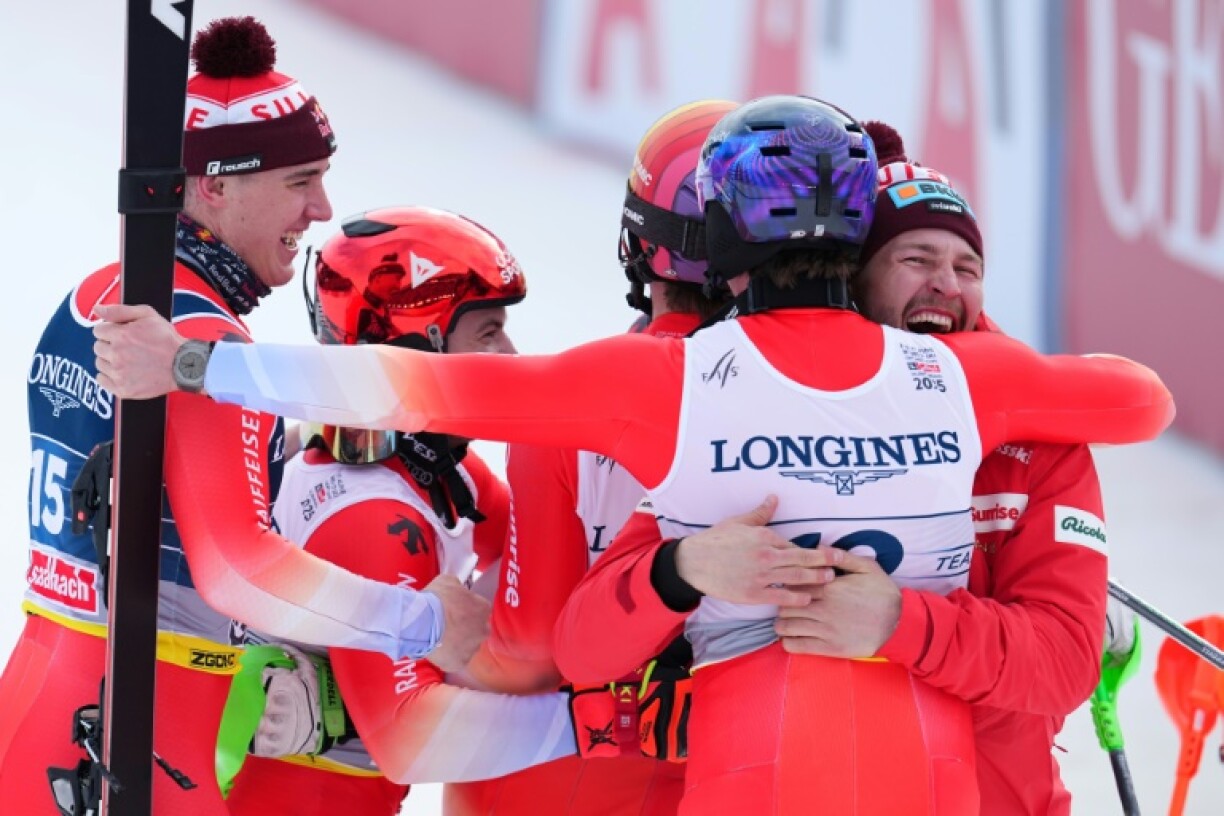 (From L) Switzerland's Franjo von Allmen, Loic Meillard, Marc Rochat and Switzerland's Alexis Monney celebrate