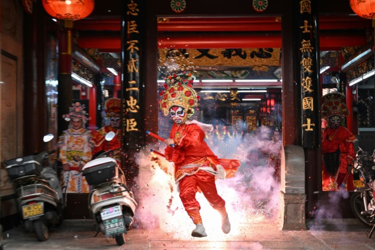 40 young dancers leap through the streets of Shantou in southern China to the sound of gongs and drums