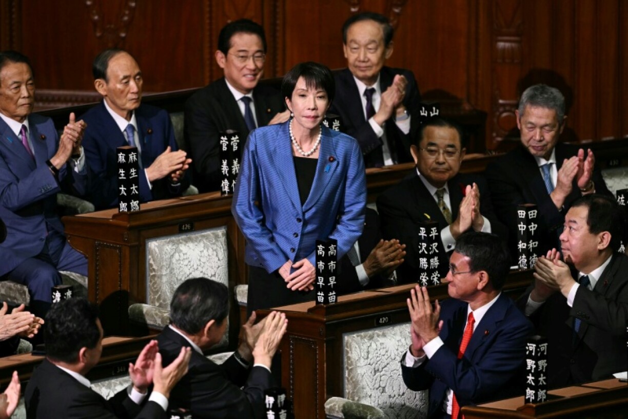 Liberal Democratic Party (LDP) President Sanae Takaichi stands up to acknowledge the applause after she was selected as Japan's new prime minister