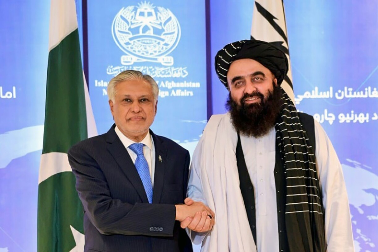 Pakistan Foreign Minister Ishaq Dar (L) with his Afghan counterpart Amir Khan Muttaqi during a visit to Kabul