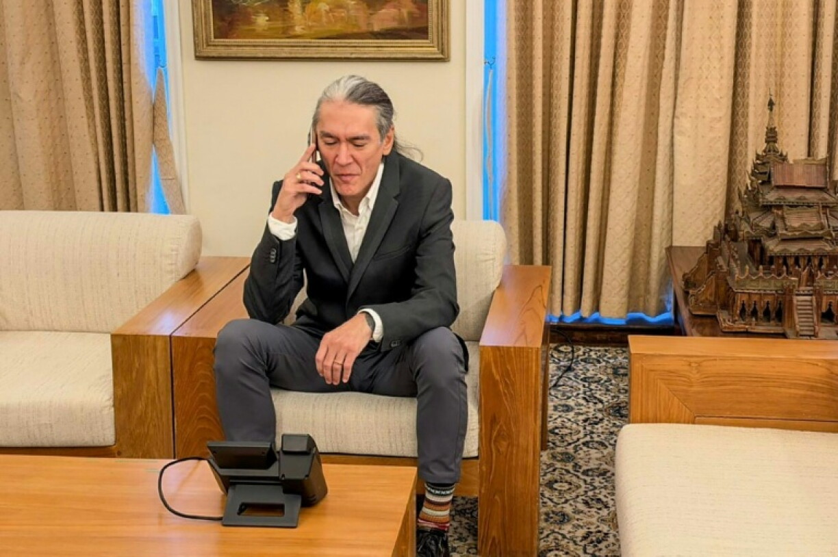 A handout photo taken and released on October 22, 2026 shows Kim Aris speaking on the phone to his mother from the Myanmar Embassy in London
