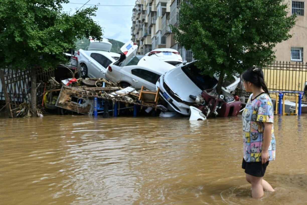 Swathes of northern China have been hit by torrential downpours and flooding, forcing tens of thousands to be evacuated, killing over thirty people