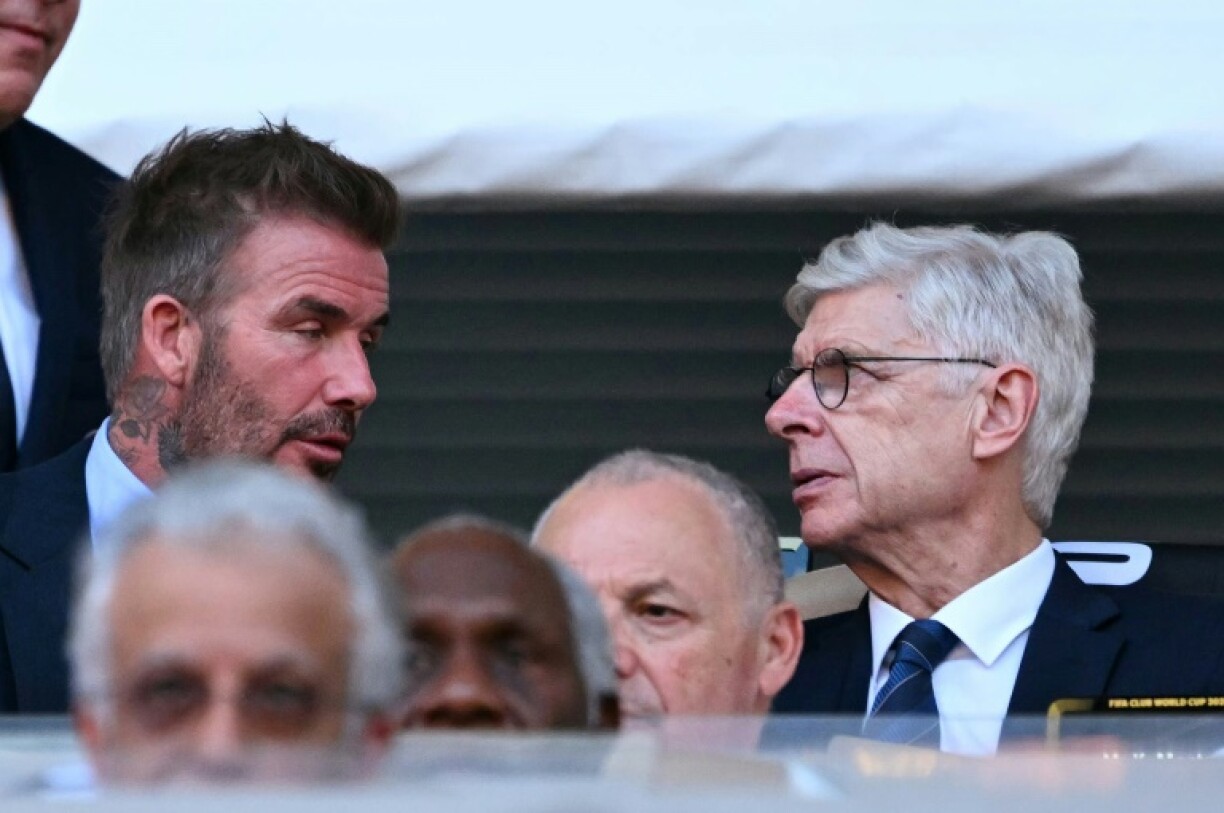 FIFA's Arsene Wenger talks with David Beckham during the Club World Cup's opening match between Egypt's Al Ahly and Inter Miami at the Hard Rock stadium