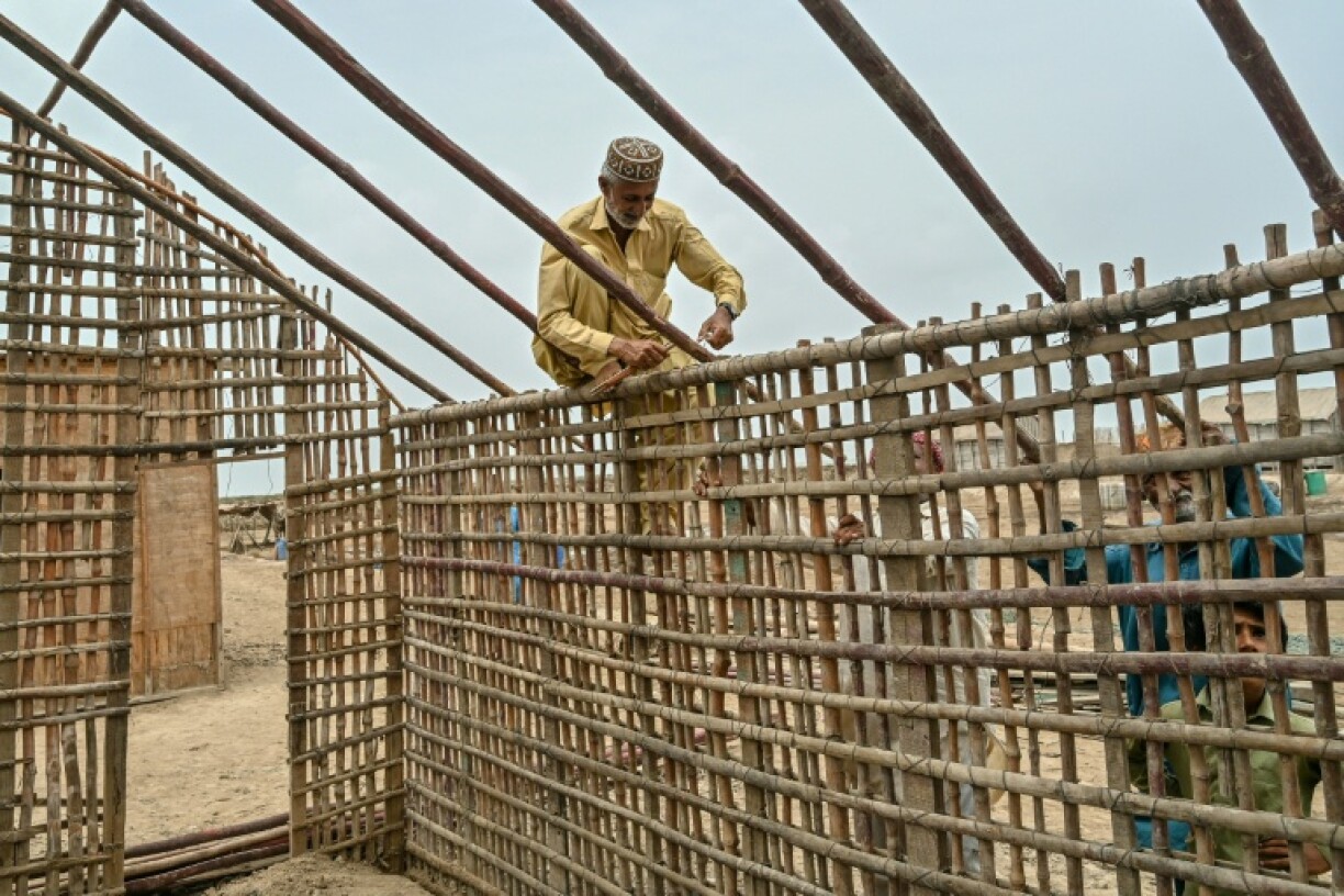 Haji Karam Jat, whose house was swallowed by the rising water level, rebuilt his new hom farther inland