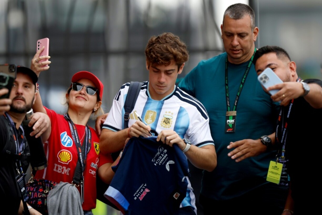 Franco Colapinto wearing an Argentina football shirt as he arrives for practice at the Brazilian Grand Prix has been busy signing things