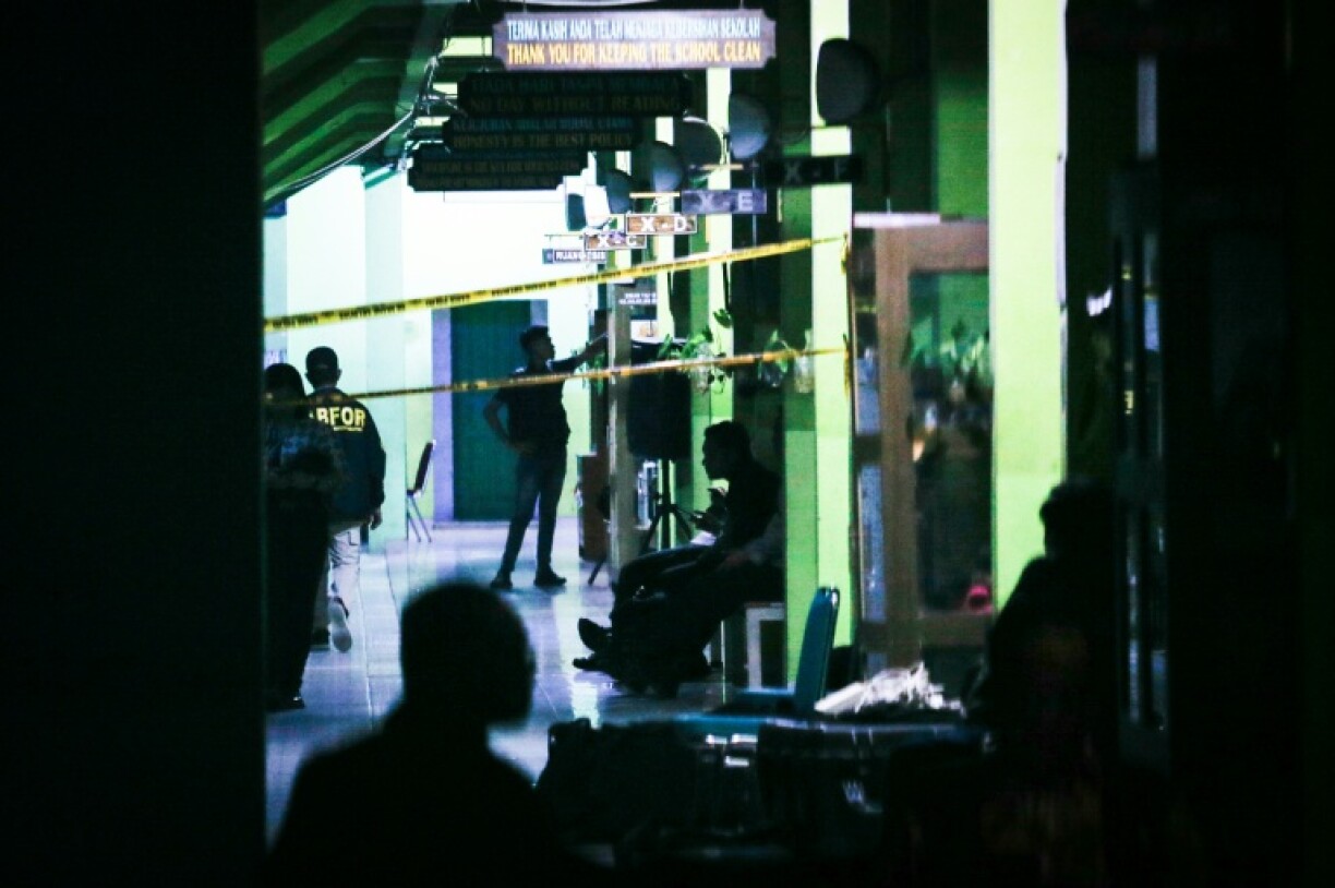 Authorities investigate the aftermath of blasts at a high school in Jakarta on November 7, 2025