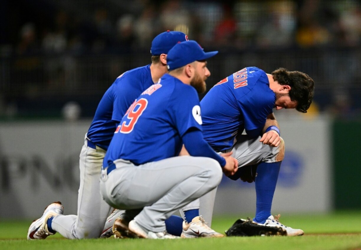 Dansby Swanson and Michael Busch of the Chicago Cubs look on after a fan fell from the stands during the seventh inning of the Cubs' game against the Pittsburgh Pirates at PNC Park in Pittsburgh