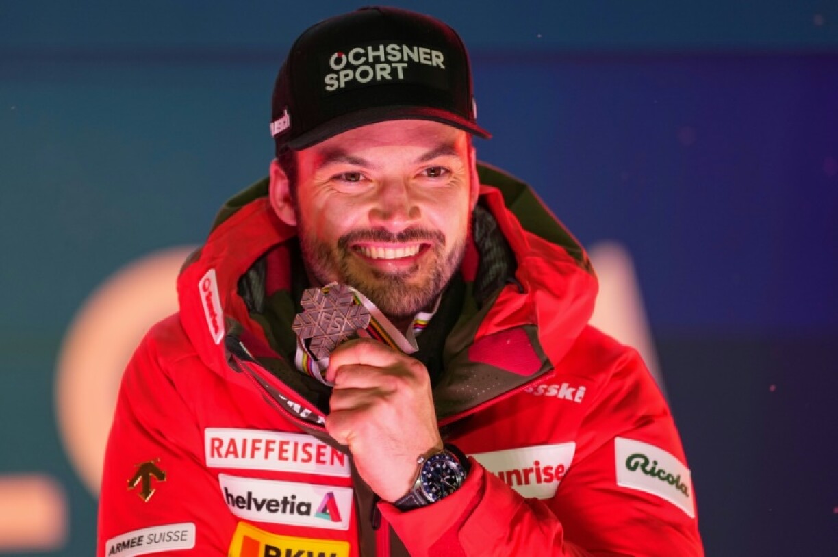 Third-placed Loic Meillard poses after the medal ceremony for the men's giant slalom