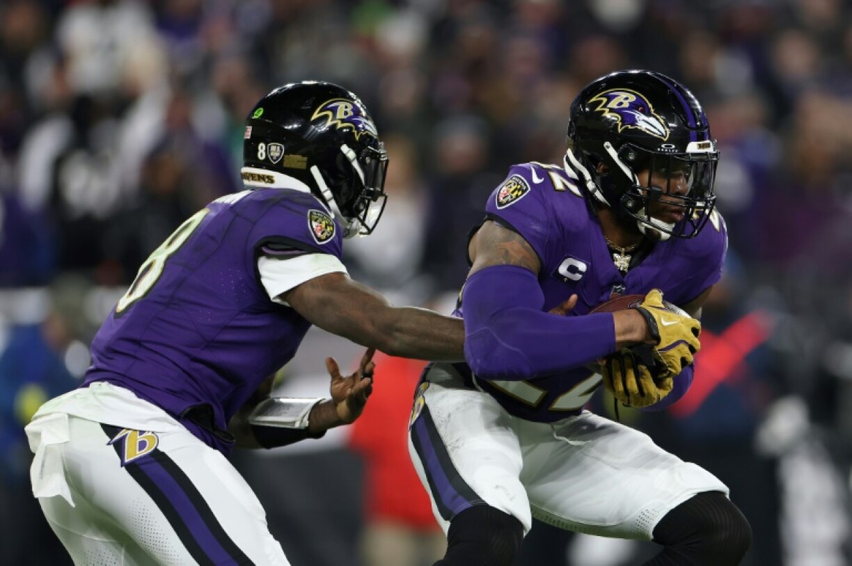 Baltimore quarterback Lamar hands off to Derrick Henry in the Raven's NFL playoff victory over the Pittsburgh Steelers