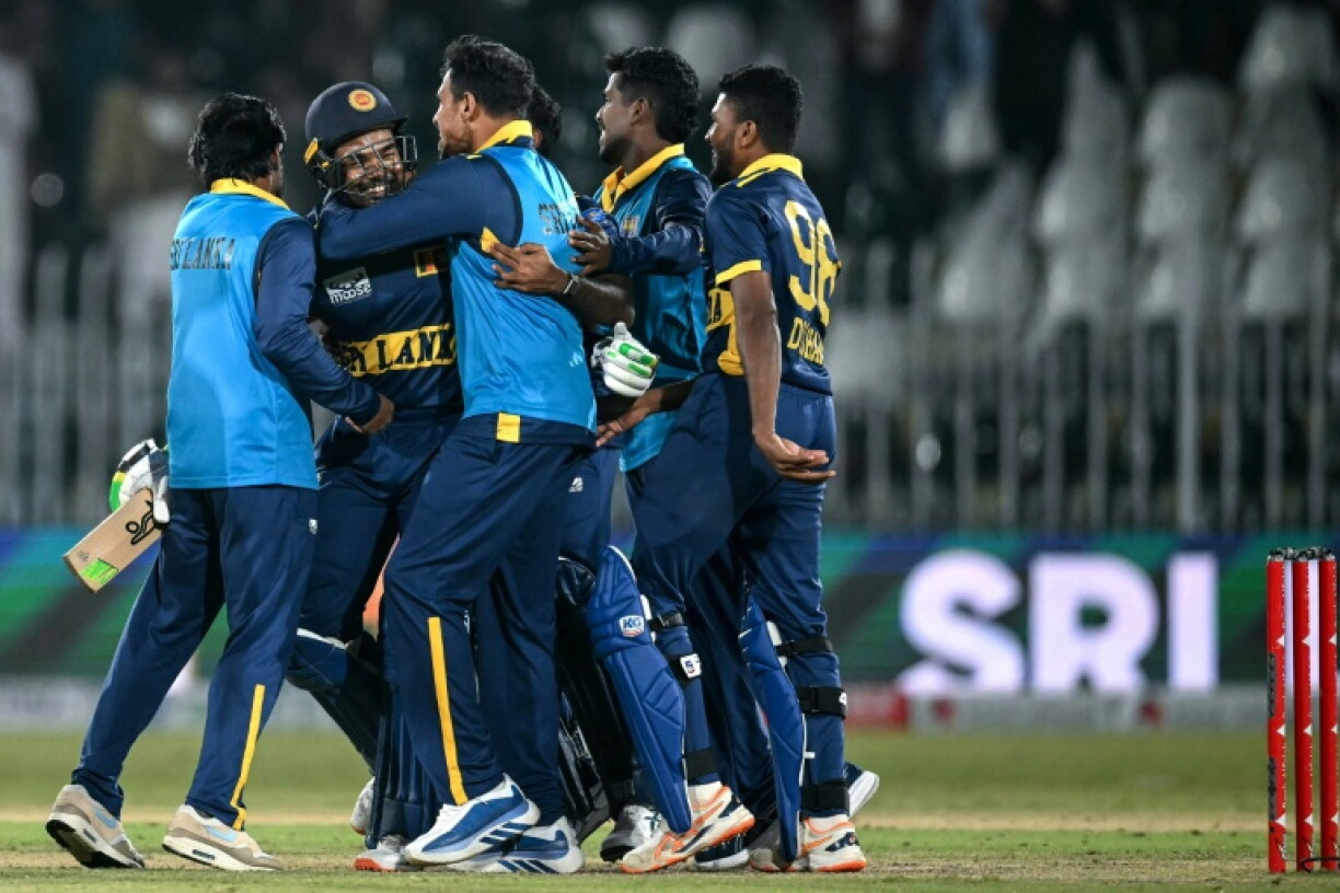 Sri Lanka's Janith Liyanage (2L) is mobbed by his teammates after hitting the winning six