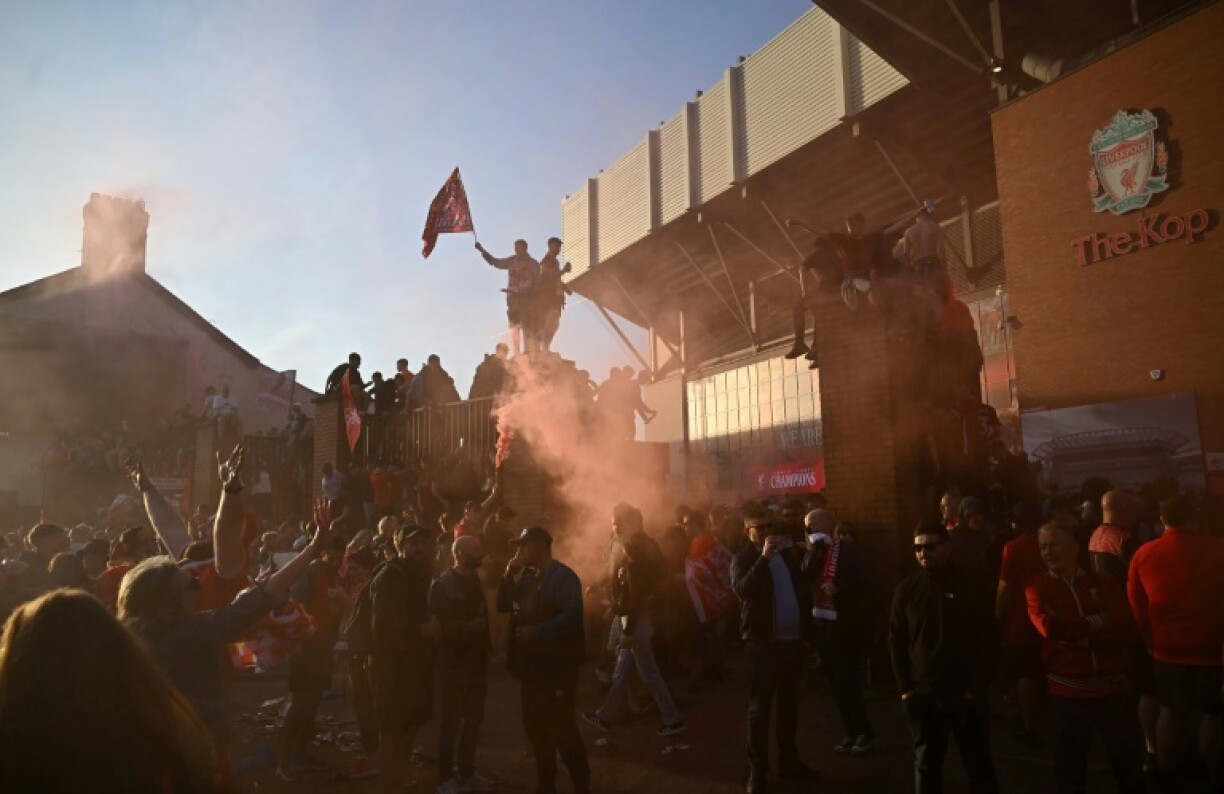 Liverpool fans celebrate winning the Premier League title outside Anfield