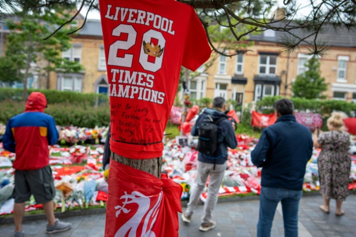Fans leave flowers, scarves and shirts near Anfield stadium in memory of Diogo Jota