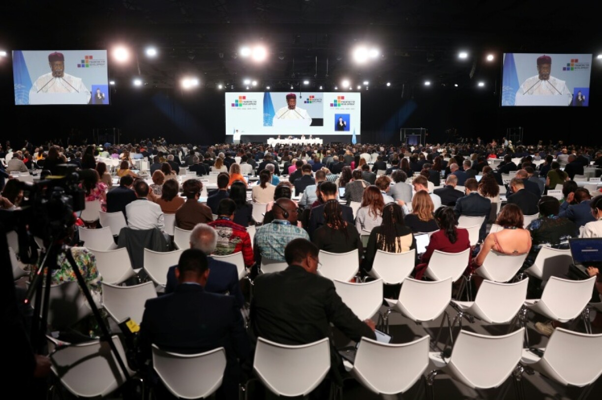 Delegates attend a plenary meeting at the UN 4th International Conference on Financing and Development in Seville on Monday