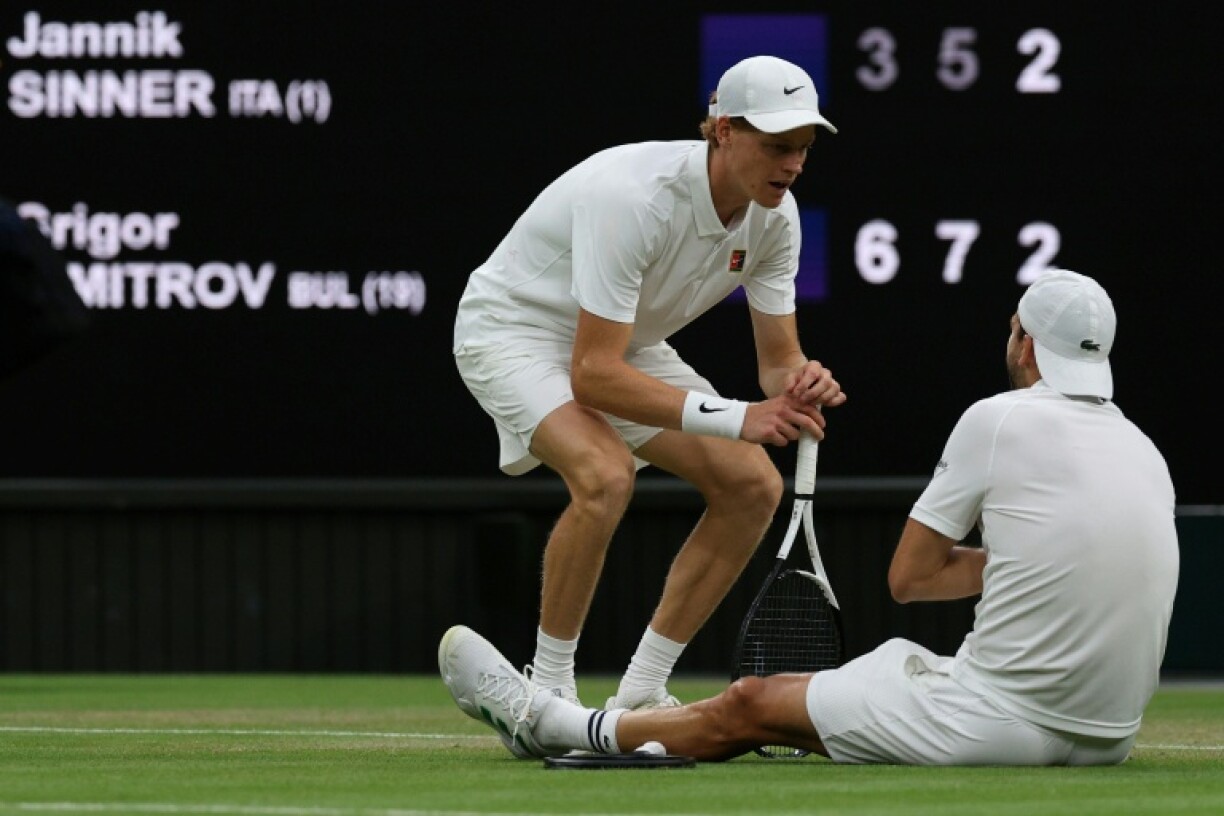 Grigor Dimitrov (right) speaks with Italy's Jannik Sinner after picking up an injury during their last-16 match at Wimbledon