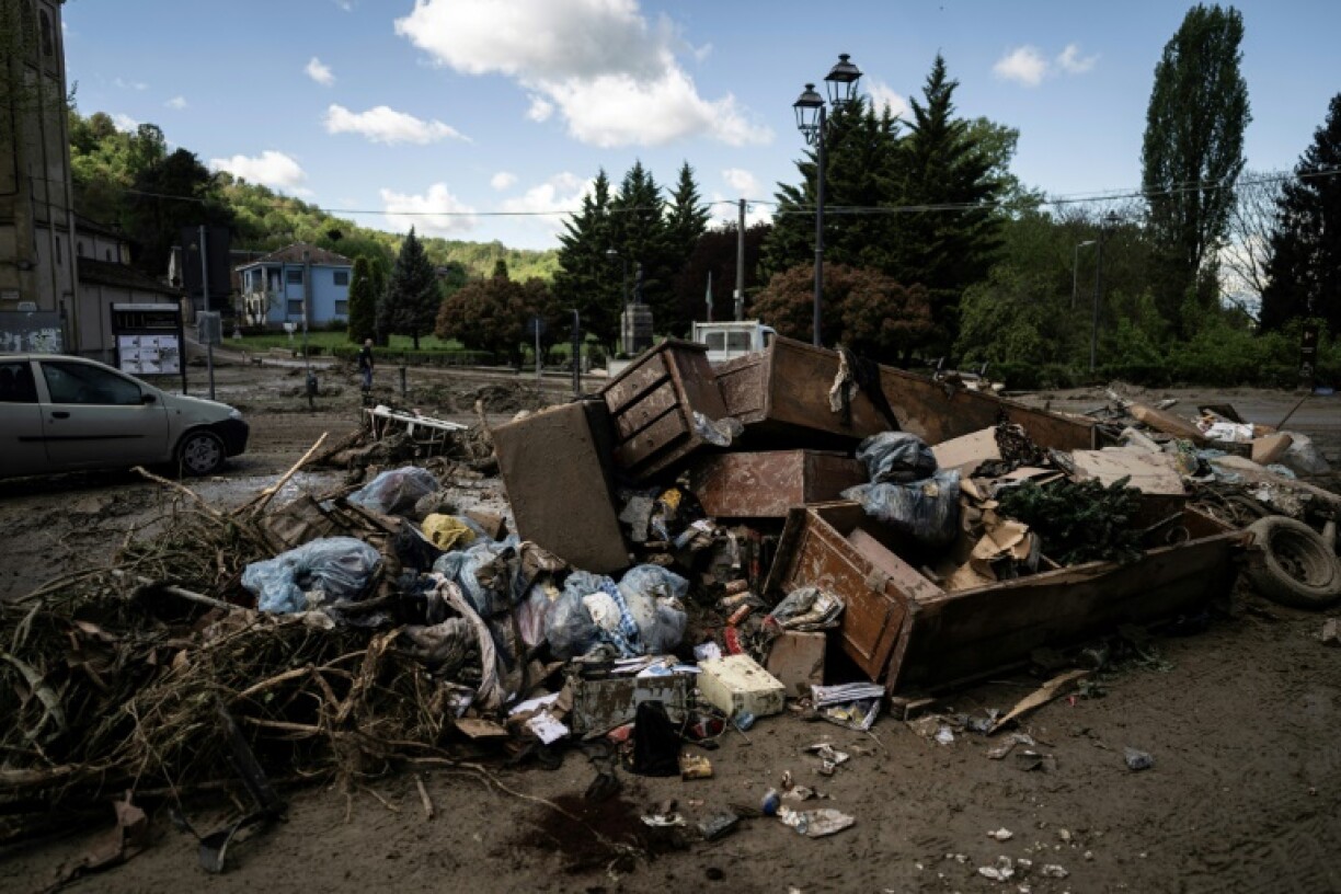 Damaged furniture in mud-covered streets after heavy rains and flooding near Turin, in the Italian Alps, in April 2025