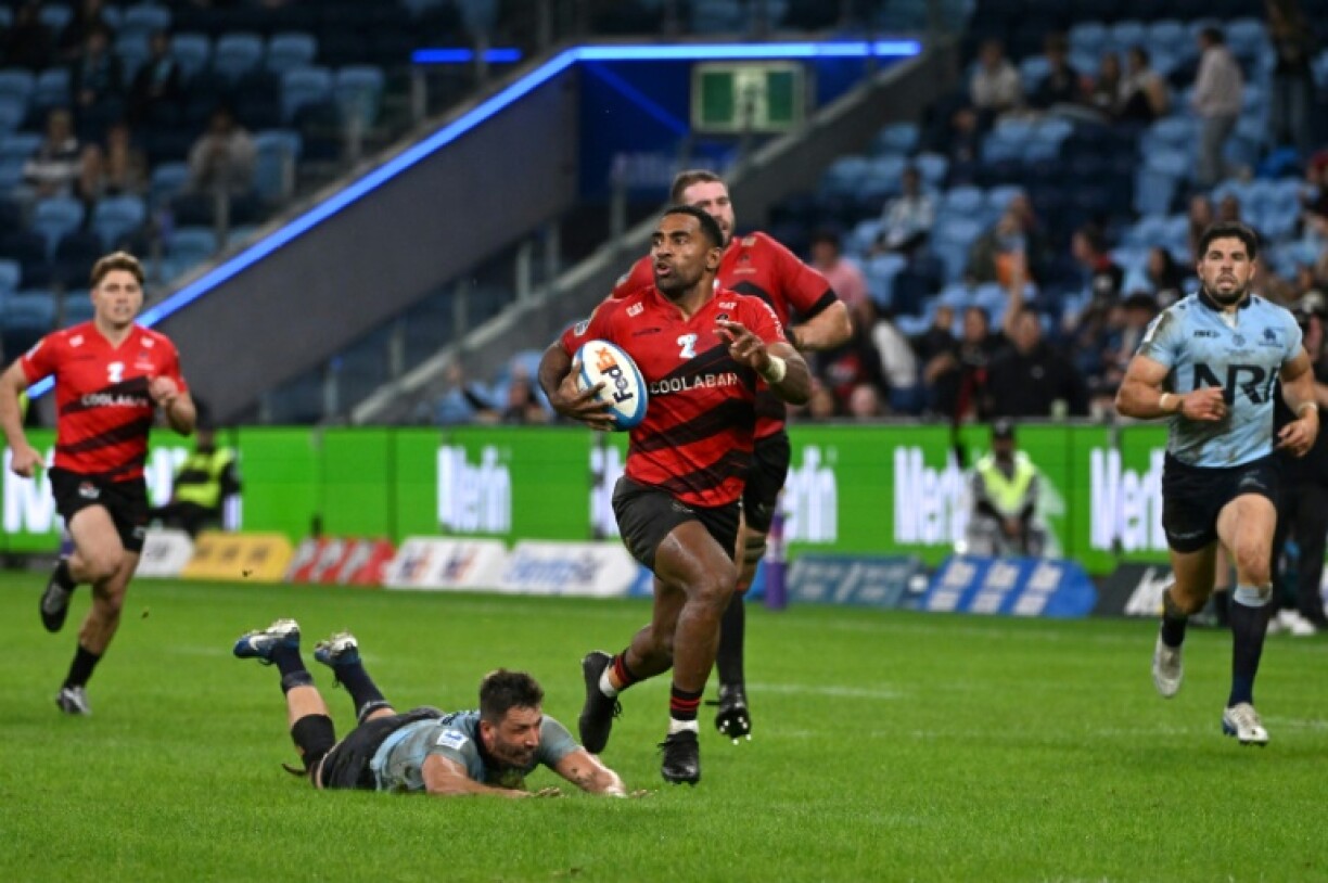 Canterbury Crusaders' Sevu Reece (C) runs the ball for a try during a Super Rugby match against the New South Wales' Waratahs in Sydney on May 16, 2025