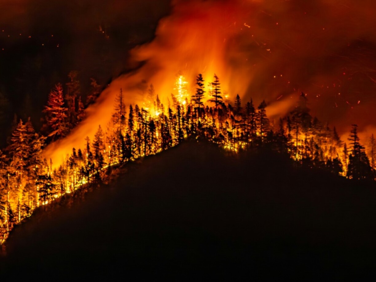A wildfire burns on Mount Underwood near Port Alberni, Canada on August 12, 2025
